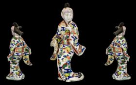 Japanese Antique Imari-Style Figure of a courtesan wearing a flowing gown,