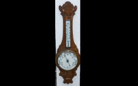 Edwardian Carved Oak Aneroid Banjo Shaped Barometer, with a porcelain dial. Size 32".