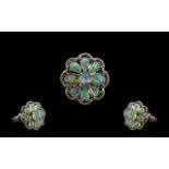 Opal Cluster Ring, comprising eight oval cut cabochons of opal with a generous display of colours,