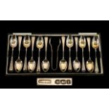 A Boxed Set of 12 Silver Teaspoons with