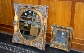 Two Ornate Gilt Framed Mirrors with deep frames, the larger measures approx.