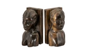 Pair of Carved African Hardwood Book Ends in the form of a man and woman, head and shoulders.