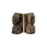 Pair of Carved African Hardwood Book Ends in the form of a man and woman, head and shoulders.