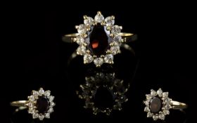 A Vintage 9ct Gold Attractive Garnet And CZ Set Cluster Ring. Flower head design.