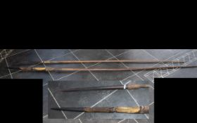 Zulu Throwing Spears, two large wooden spears with wooden shafts and pointed ends, leather clad.