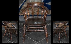 An Antique Captains Beech Arm Chair on turned bulbous legs and shaped spindle back.