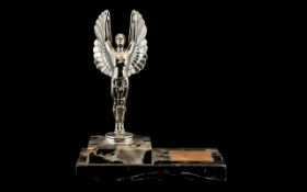 Art Deco Chrome Figure of Icarus mounted on a variegated black marble stepped base,