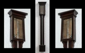 A Georgian Antique Mahogany Stick Barometer - with glazed exposed door with paper label.