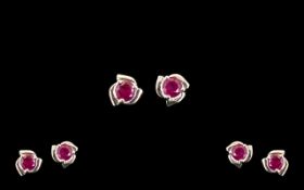 Ruby Solitaire Stud Earrings, round cut solitaire rubies totalling 1ct, each set in a three part