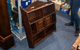 An Edwardian Mahogany Aesthetic Design Hanging Wall Cabinet with shelves and two centre cupboards.