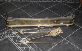 Early Victorian Brass Fender with fretwork slits to the front, terminating on bun feet,