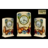 Moorcroft Clock in cream with bright floral decoration, stamped WM and Moorcroft to base of clock.