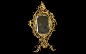 Gilt Rococo Style Table Mirror. Gilt table mirror decorated with cherubs, bevelled glass mirror, 15.