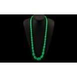 A String of Jade Lucite Graduated Beads. 30 inches in length.