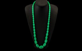 A String of Jade Lucite Graduated Beads. 30 inches in length.