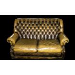 Leather Two Seater Chesterfield Sofa in brown colour, with rolling arms and two loose seat cushions.