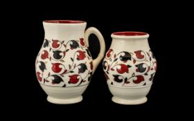 Crown Ducal Jug and matching decorative pot. Red and black pattern on cream ground.