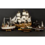 Four Model Ships comprising a Sailing Boat measuring 18" x 20"; a Trawler 9" high x 10" width;