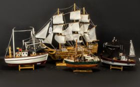 Four Model Ships comprising a Sailing Boat measuring 18" x 20"; a Trawler 9" high x 10" width;