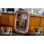 Two Decorative Mirrors one large oval shaped mirror in unusual wooded carved frame with bronze