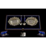 Late Victorian Period Boxed Pair of Silver Salts With Spoons. Ornate shaped borders.