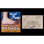 Monty Python Autographs in their book five signatures: Eric Idle, Terry Jones, Michael Palin,