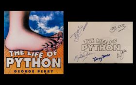 Monty Python Autographs in their book five signatures: Eric Idle, Terry Jones, Michael Palin,