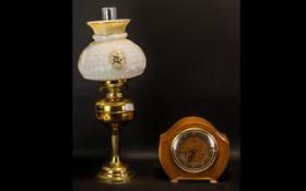 A Duplex Brass Oil Lamp with glass shade. Made in England. Measuring 21 inches in height.