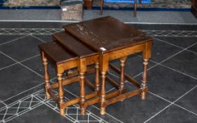 Nest of Three Oak Tables, each raised on four column legs. Measuring tallest: 20" Length, 15.