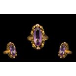 14ct Gold Attractive Single Stone Amethyst Set Ring, Well Designed Setting. The Elongated Faceted