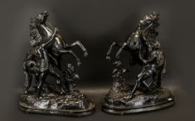 Two Metal Figures of Rearing Horses each with figure of man holding the bridle.