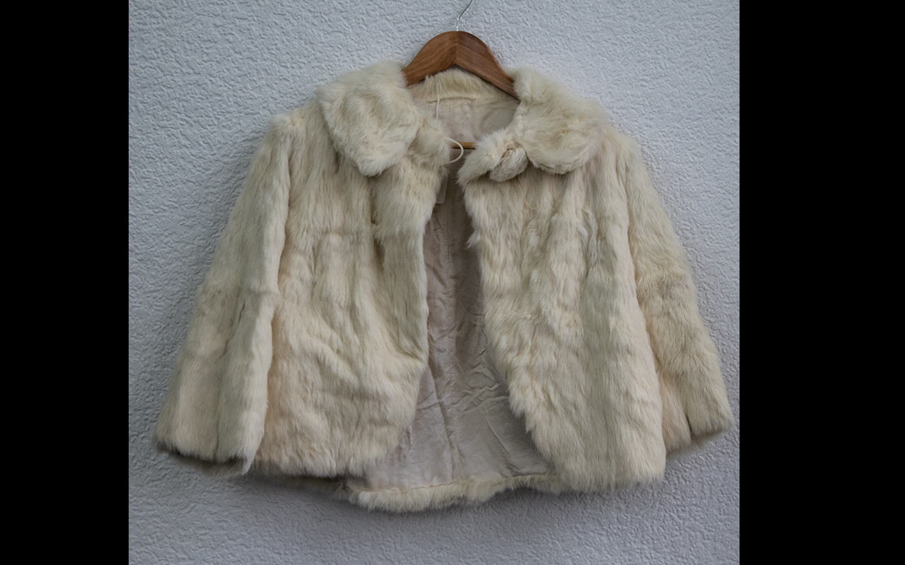 Ladies Cream Fur Jacket. Fastens at top with button. Pale gold lining. Small size 8.