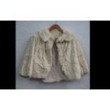 Ladies Cream Fur Jacket. Fastens at top with button. Pale gold lining. Small size 8.