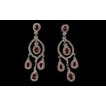 Faux Ruby and Diamond Chandelier Earrings, the pear cut faux rubies being the feature stones on a
