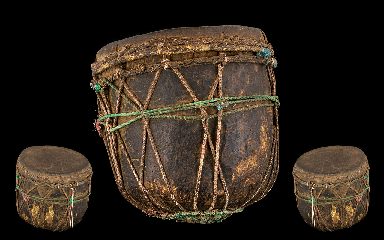 Tribal Antique Wood Drum hewn form a tree trunk with a skin applied. Decorated in string cords. 10