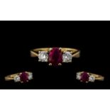 Ladies 9ct Gold 3 Stone Ruby and Diamond Set Dress Ring - the central ruby flanked by two brilliant