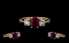 Ladies 9ct Gold 3 Stone Ruby and Diamond Set Dress Ring - the central ruby flanked by two brilliant