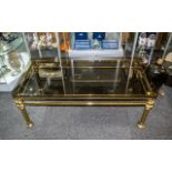 Glass Topped Coffee Table. Attractive tinted glass top table with brass scrolled legs, measures 47''
