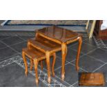 Nest of Three Walnut Tables with inlaid veneer decoration to tops,