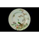 A Chinese Antique Famille Rose Plate decorated in coloured enamels depicting a peacock amongst