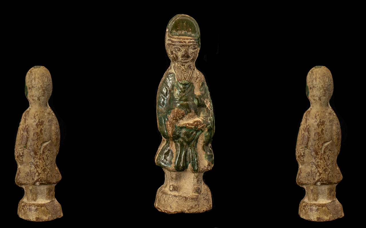 Early Ming Period Pottery Tomb Figure of an official, decorated with a green splash glaze. Height