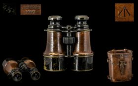Military Interest - French WWI 1917 Binoculars housed in a brown leather case embossed with the