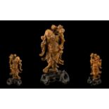 Chinese Boxwood Carved Figure of a Deity holding a branch of peaches on a hardwood base.