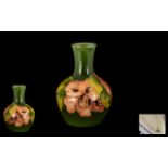 Moorcroft Small Tubelined Global Shaped Vase - 'Coral Hibiscus' design on green ground.