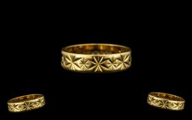 18ct Gold Wedding Band with deep cut decoration to outer side. Full hallmark London 1969.