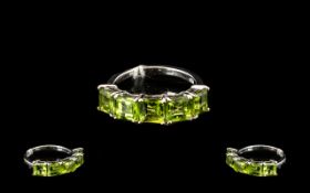 Peridot Band Ring, five square cut peridots, totalling 3.