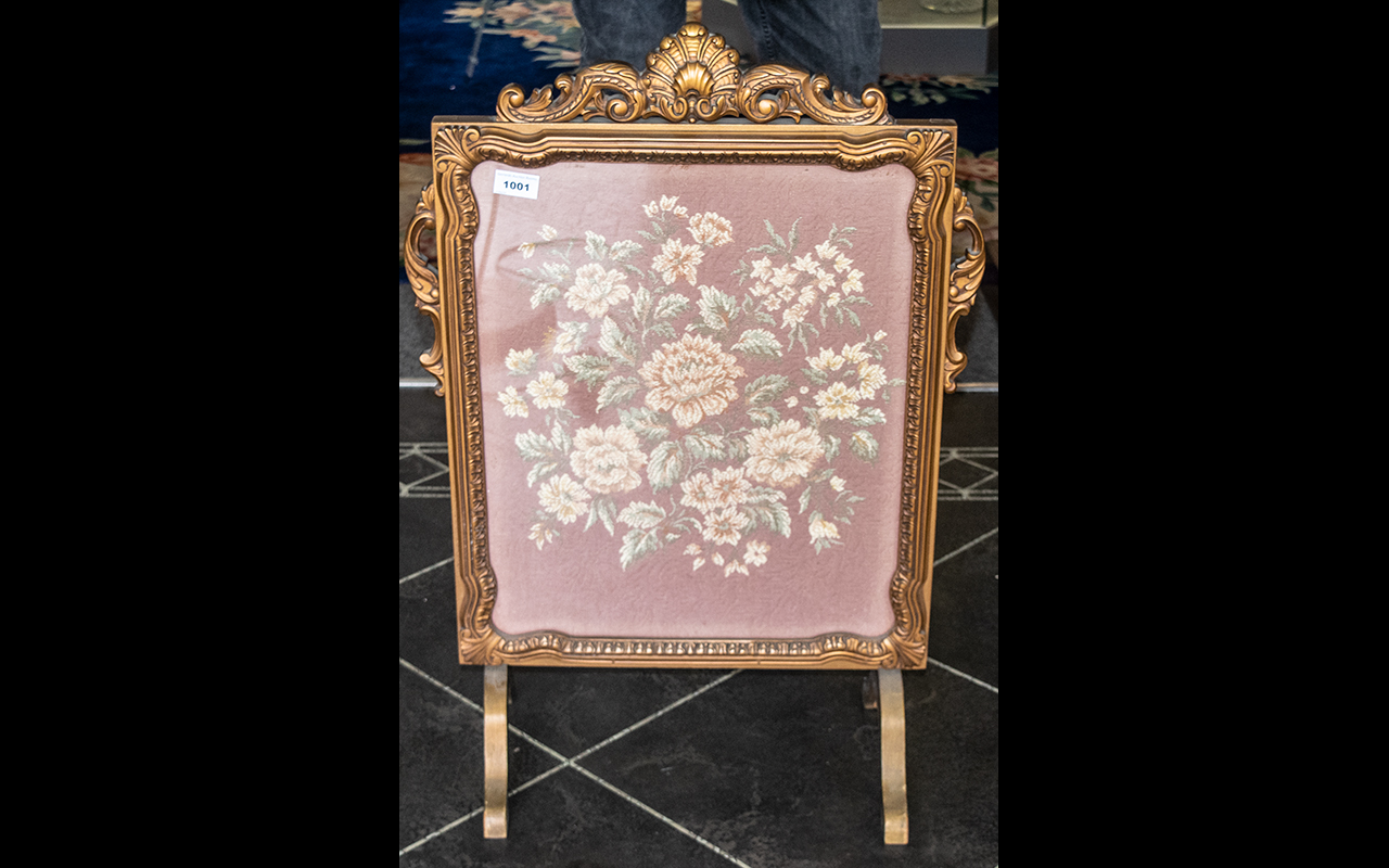 1930's Embroidered Fire Screen in Giltwood carved frame with shape feet supports. 30'' high, 22''