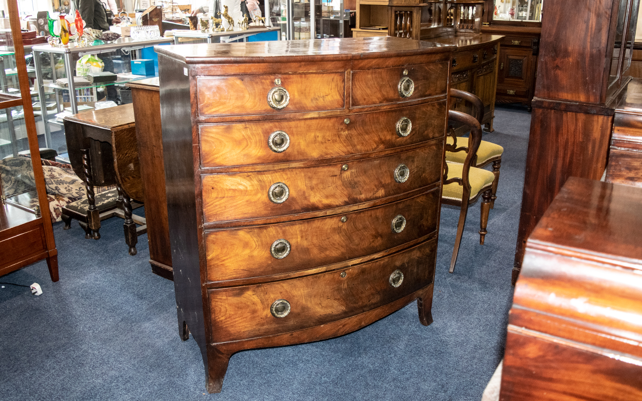 A Late Regency Period/ Georgian Large Bow Fronted Mahogany Chest with graduating drawers.