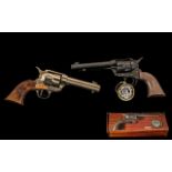Two Replica Pistols one boxed (actual size) Colt Army .45. Also, Madera Bois Holz.