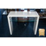 A Contemporary White High Gloss and Glass Console Table. 30 inches in height and 35 inches wide.